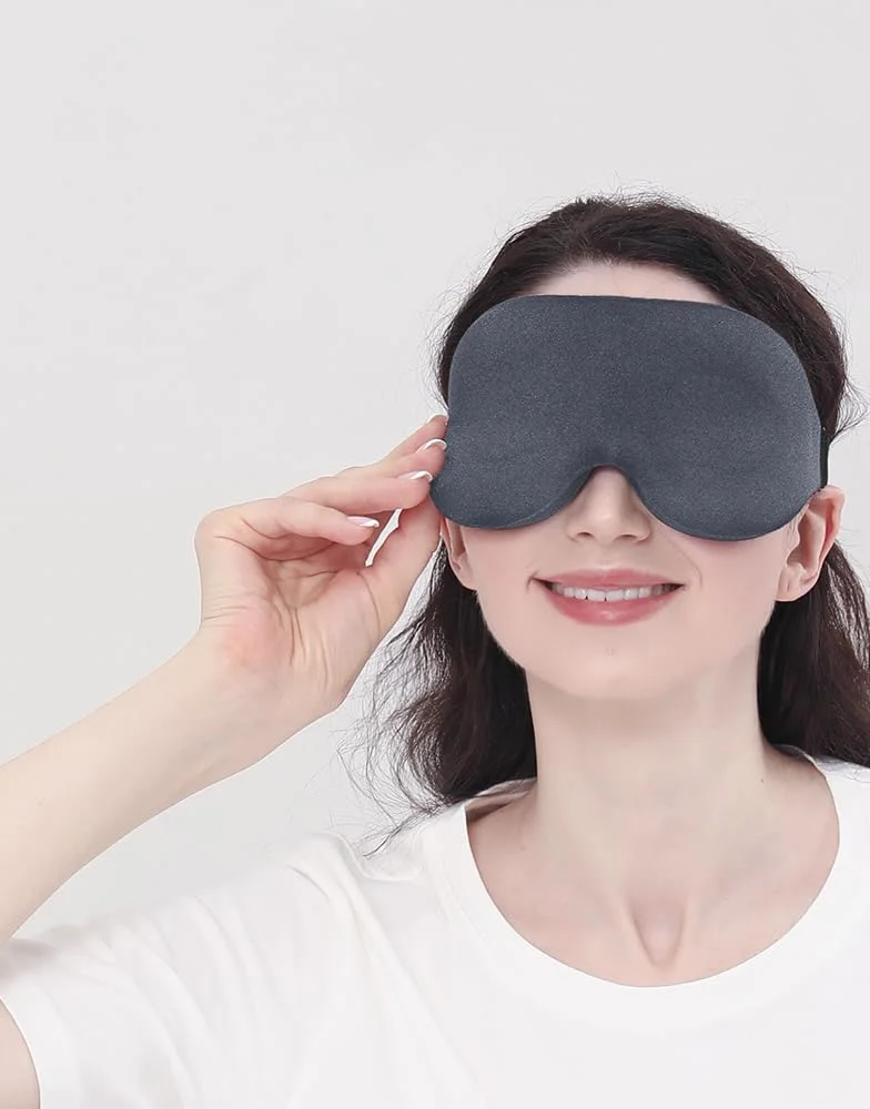 A woman settles a gray MZOO Contoured mask, its nose cutout sitting over the bridge of her nose.